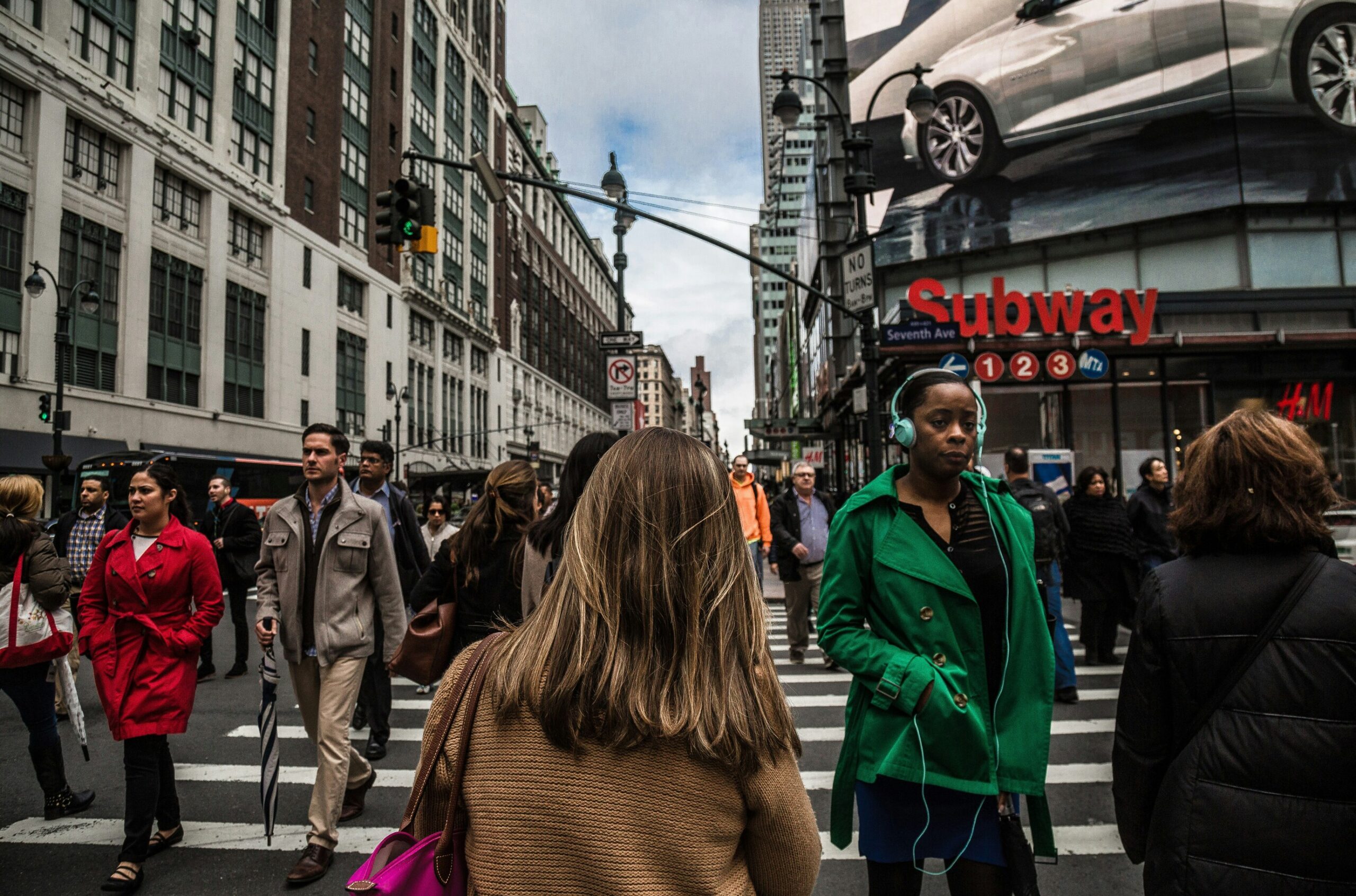 woman walking on busy street in city